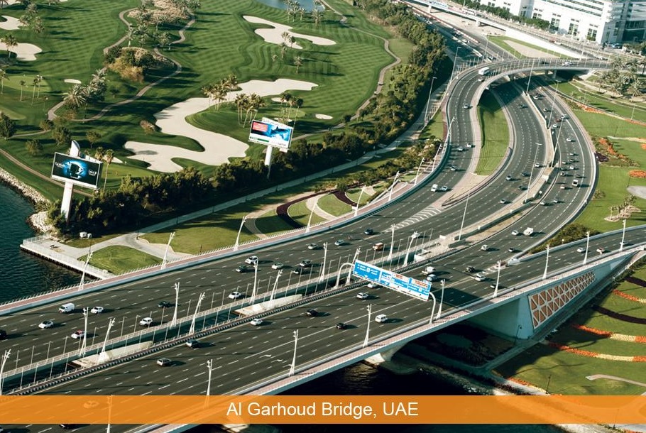 Al Garhoud_a train traveling over a bridge over a river