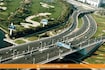 Al Garhoud_a train traveling over a bridge over a river