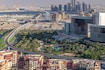 Al Jaddaf_a city street with tall buildings and a sky background