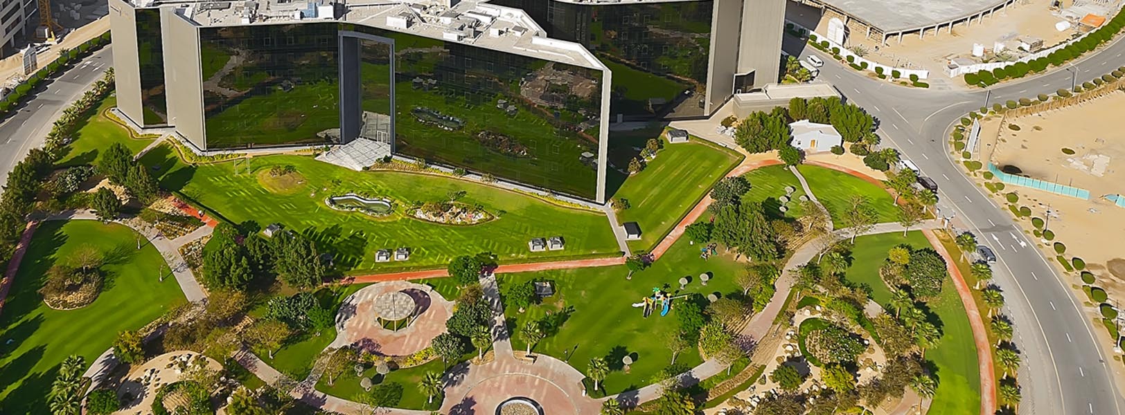 Dubai Investment Park (DIP)_an aerial view of a city with a train on the tracks