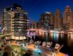 Jumeirah Beach Residence (JBR)_a city at night filled with lots of tall buildings