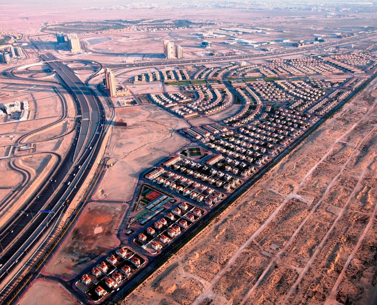 Jumeirah Village Triangle (JVT)_an aerial view of a city with many train tracks
