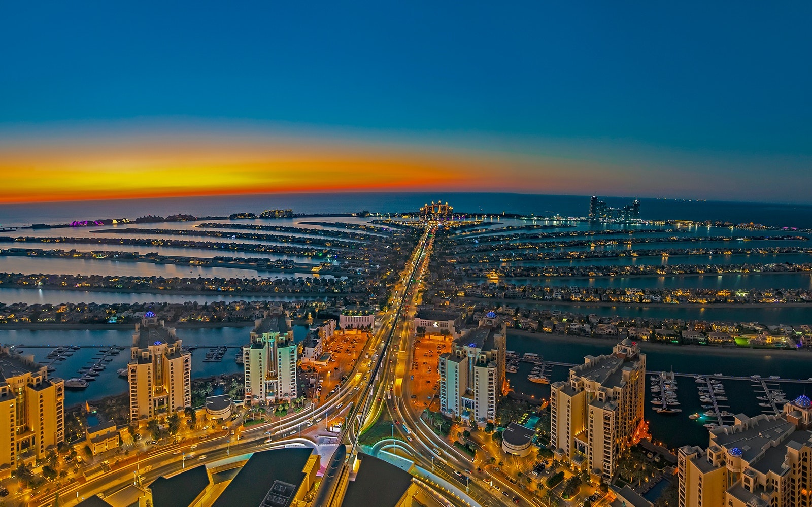 Palm Jumeirah_a city at night with skyscrapers in the distance