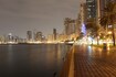 Al Khan_a city street at night with a large body of water